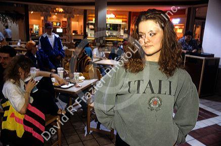 A self conscious teen distances herself from the crowd.