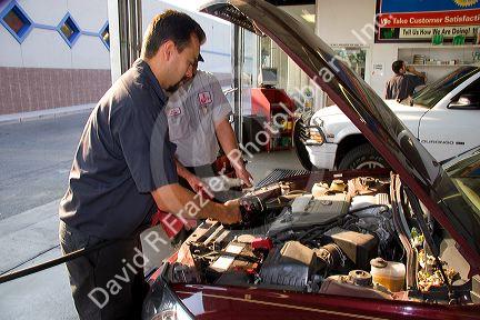 Mechanics giving an automobile an oil change in Boise, Idaho. MR