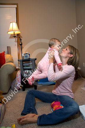 A mother playing with her infant child. MR