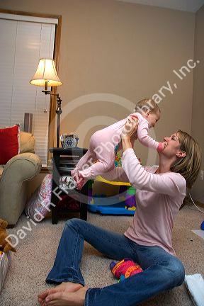 A mother playing with her infant child. MR