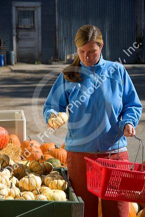 A woman shoping at a farmers market in Canyon County, Idaho. MR
