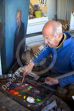 An artist painting a portrait on canvas in Boise, Idaho. MR