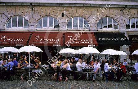 People eating at an outdoor cafe at Covent Garden in London, England.