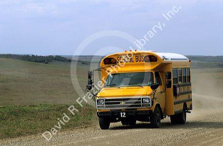 A school bus traveling on a rural dirt road in Oklahoma.