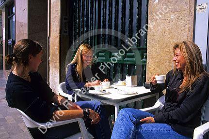 Women having coffee at an outdoor cafe in Majorca, Spain.