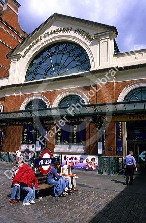 People sit on benches in front of London's Transport Museum, England.
