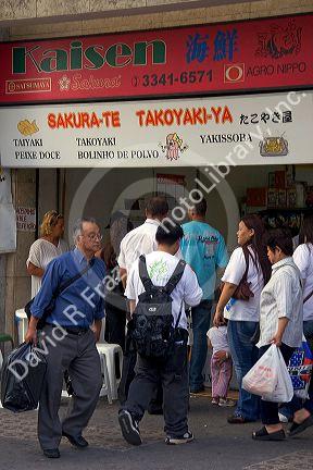 People in front of a Japanese store in the Liberdade asian section of Sao Paulo, Brazil.