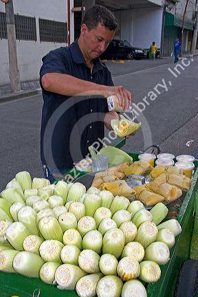A street vendor preparing a corn snack in the Liberdade asian section of Sao Paulo, Brazil.