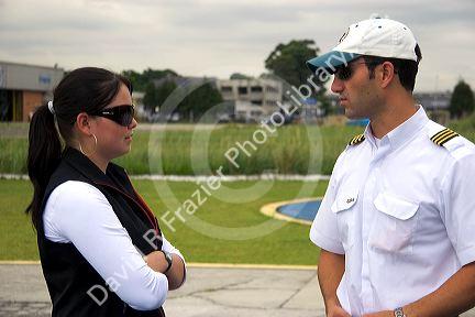 A pilot and flight office staffer talking in Sao Paulo, Brazil.