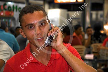 Brazilian man using a cell phone in Manaus, Brazil.