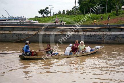 People riding in a canoe on the Amazon River near Manaus, Brazil.
