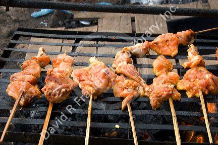 Chicken being cooked on a grill in the Amazon, Brazil.