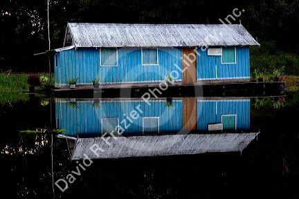 A floating general store on the Arasa River in the Amazon jungle near Manaus, Brazil.