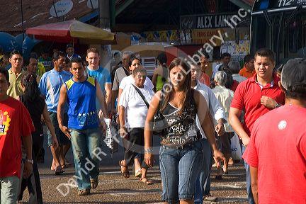 Pedestrians a bus stop in Manaus, Brazil.