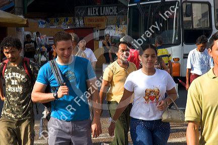 Pedestrians at a bus stop in Manaus, Brazil.
