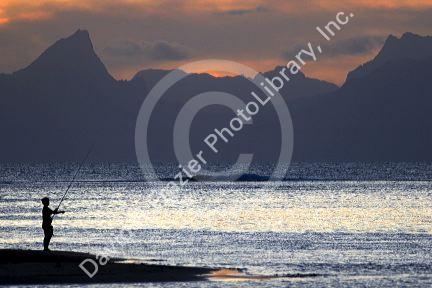 Fishing at sunset from Point Venus on the island of Tahiti.