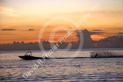 Water skiing at sunset off the island of Tahiti.