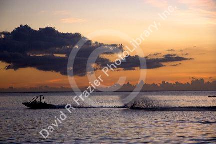 Water skiing at sunset off the island of Tahiti.