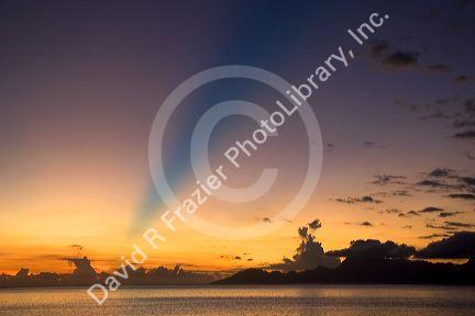 Sunset from the island of Tahiti. The blue band in the sky is believed to be the shadow cast from a mountain on a distant island.