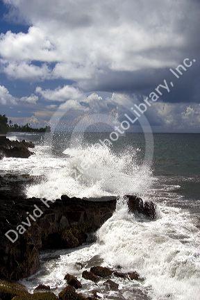 Waves crash on rocks on the island of Tahiti.