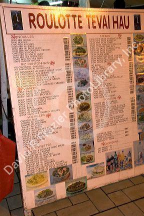 The menu board for a roulotte, food van in Papeete on the island of Tahiti.