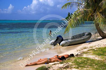 Women sunbathing topless on the island of Moorea. MR