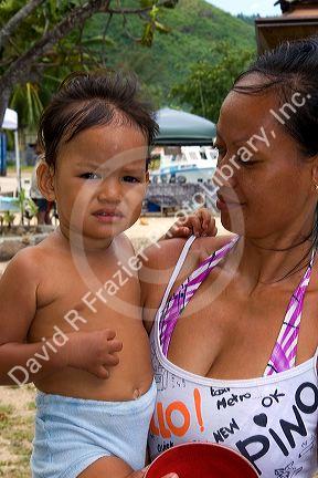 Tahitian woman and child on the island of Moorea.