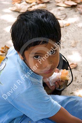 Young Tahitian boy having lunch on the island of Moorea.