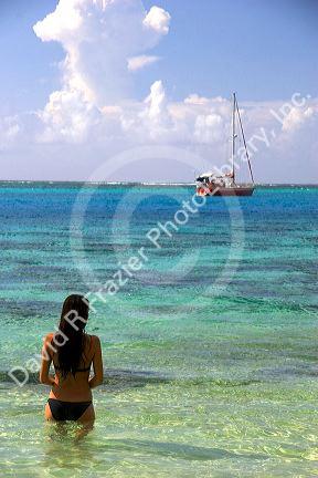 Tahitian woman standing in the lagoon on the island of Moorea. MR