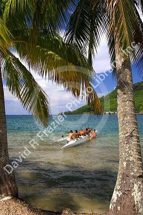 Tahitians participate in an outrigger canoe pirogue race off the island of Moorea.