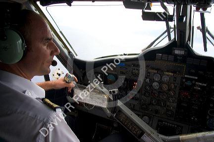 Pilot of Twin Otter aircraft at the controls in the cockpit.