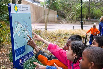 Children point at a map of the National Zoo in Washington, D.C.
