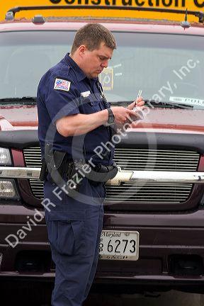 Police officer writing parking tickets in Washington, D.C.
