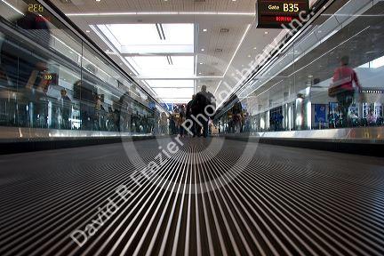 People ride on a moving walkway at the Denver International Airport, Colorado.