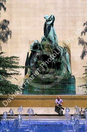 Man reading outside the Art Institute of Chicago, Illinois.