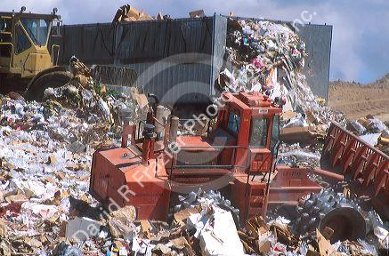 Sanitary landfill with  compactors at work.