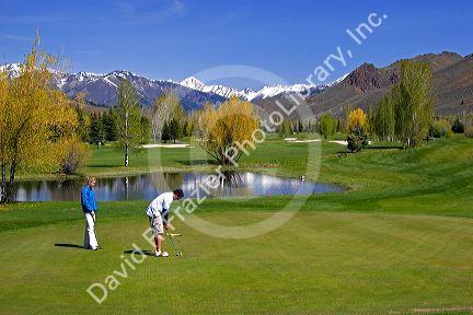 Golfing in Sun Valley, Idaho with Boulder Mountains in the background.