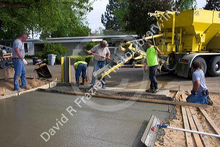 Workers pouring a cement driveway in Boise, Idaho.