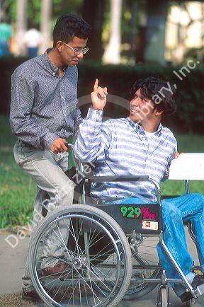 Hispanic handicapped university student in wheel chair.