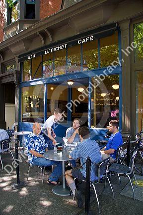 Men having coffee at an outdoor cafe in Seattle, Washington.