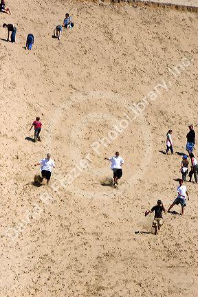 People play on sand dunes at Pacific City on the Oregon Coast.