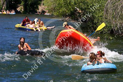 People on inflatable rafts floating the Boise River in Boise, Idaho.