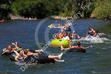 People in inflatable tubes and rafts floating the Boise River in Boise, Idaho.