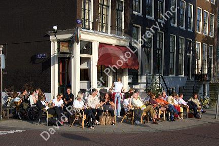 People eat and drink at an outdoor cafe in Amsterdam, Netherlands.