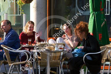 People dine at an outdoor cafe in Amsterdam, Netherlands.