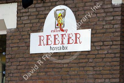 Sign for a coffee shop named Reefer in Amsterdam, Netherlands.