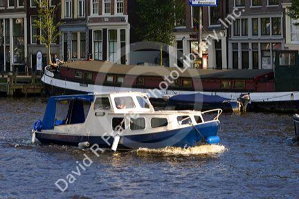 Canal boat on the Amstel River in Amsterdam, Netherlands.