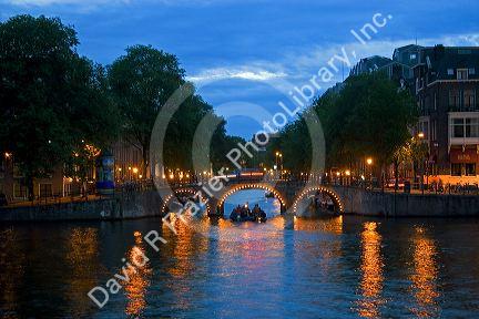 The Amstel River at dusk in Amsterdam, Netherlands.