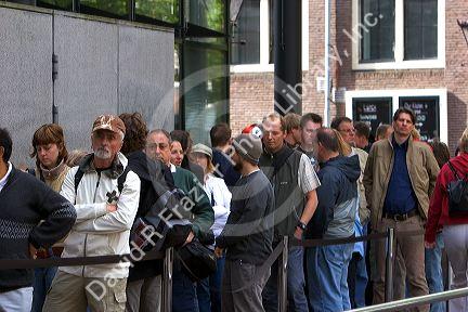 People stand in line to enter the Anne Frank House in Amsterdam, Netherlands.