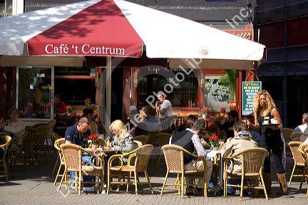People dine at an outdoor cafe in Amsterdam, Netherlands.